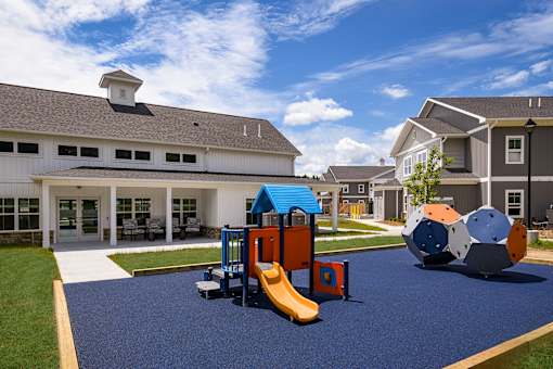 A playground area with a slide and a ball-shaped structure.