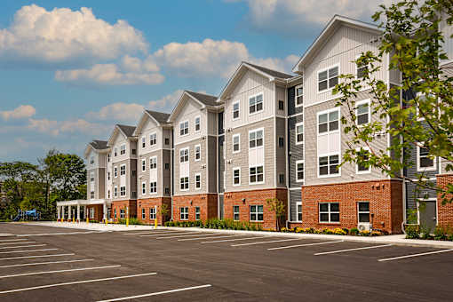 A large building with a parking lot in front of it.