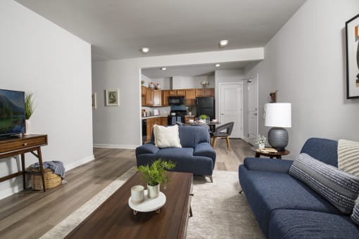 a living room with blue couches and a coffee table