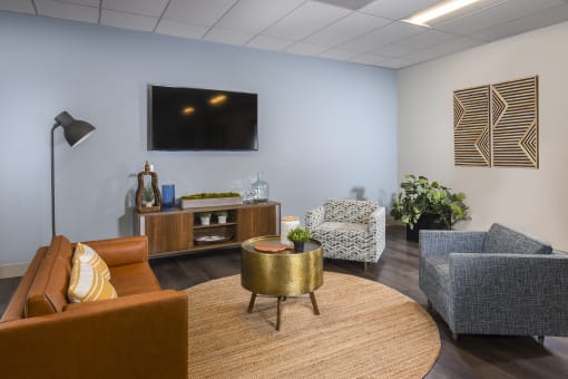 a lounge area with couches chairs and a coffee table
