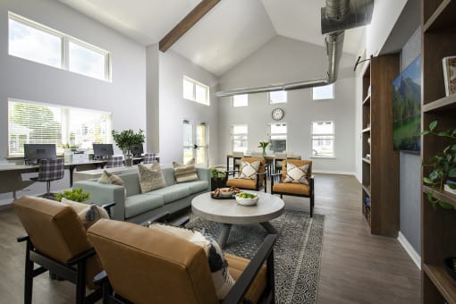 a room with couches and chairs and a table