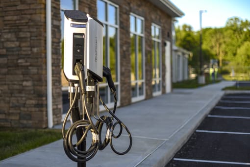 a car charger on the sidewalk in front of a building