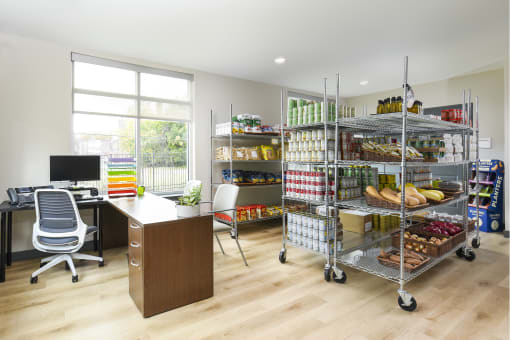 a home office with a desk and shelves of food