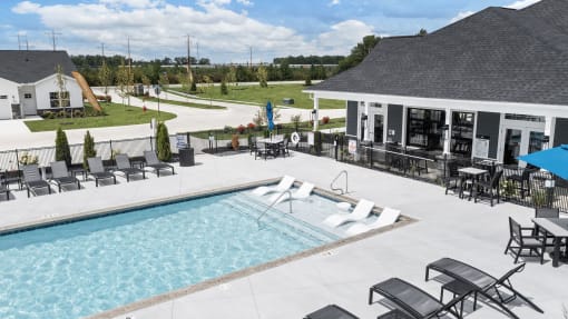 a swimming pool with chairs