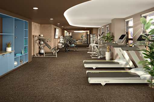 Modern fitness center with treadmills, strength training equipment, and a clean, well-lit workout environment.