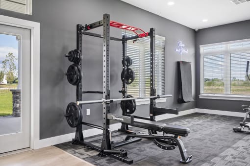 a gym with free weights and a window