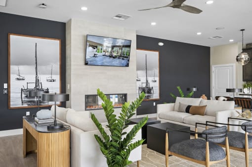 a living room with black walls and a tv on the wall