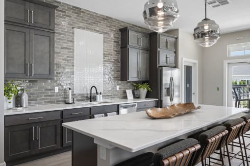 a kitchen with gray cabinets and a white counter top