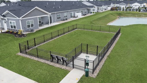 a dog park with a fenced in area in a yard
