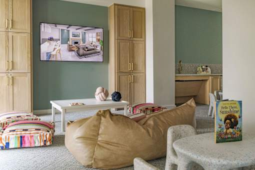 A living room with a flat screen TV mounted on the wall.