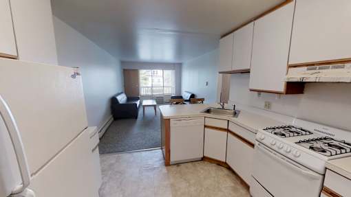 A kitchen with white appliances and cabinets.