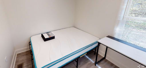 A small bedroom with a single bed and a window.