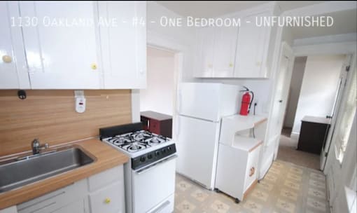 A kitchen with a stove, sink, and refrigerator.