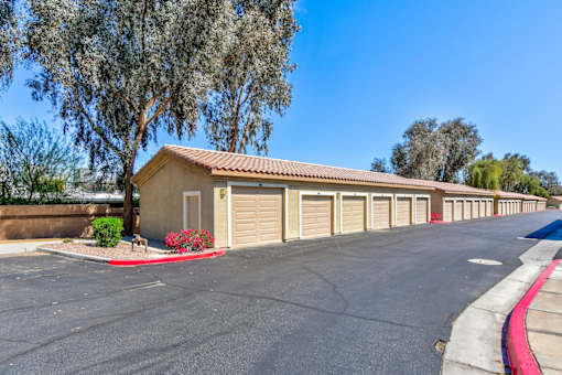 A row of garage doors are lined up on a street.