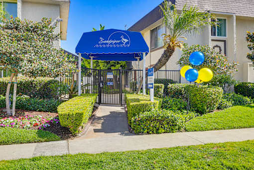 A blue canopy with the word "Sunshine" written on it is above a gate.