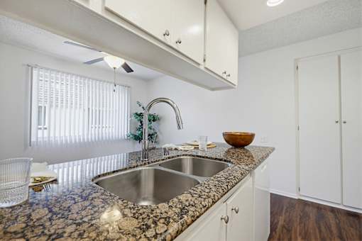 A kitchen with a granite countertop and a bowl on it.