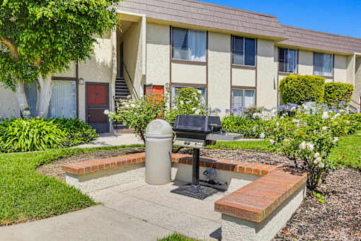 A small outdoor fire pit sits in front of a building.