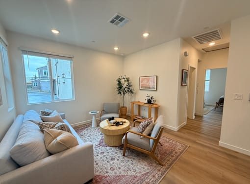 A living room with a couch, chair, and coffee table.