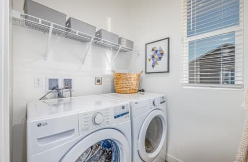 A white LG washing machine and dryer in a laundry room.