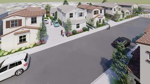 A street view of a residential area with houses and cars.