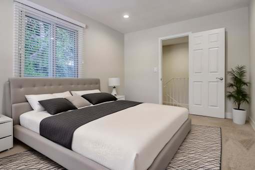 Bright bedroom with large mirrored closet and modern décor at Arbor Ranch Apartments.