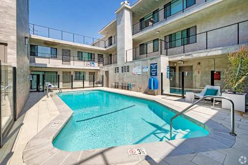 A swimming pool is located on the balcony of a building.
