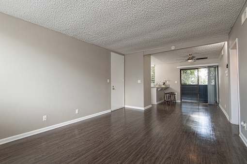 A room with wooden floors and a ceiling fan.