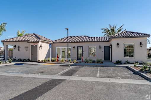 A building with a parking lot in front of it.