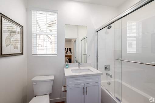 A white toilet sits next to a sink in a bathroom.