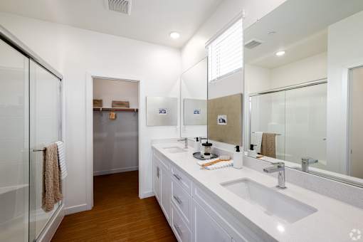 A bathroom with a white sink and a mirror.