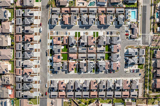 A bird's eye view of a residential area with houses and streets.