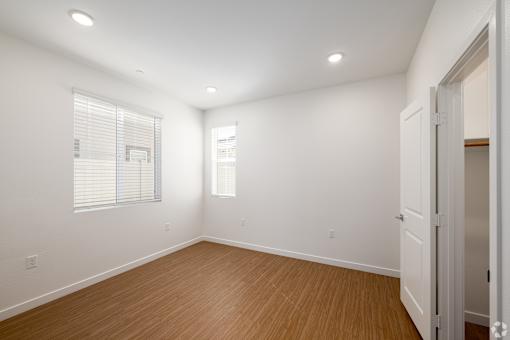 A room with wooden floors and white walls.