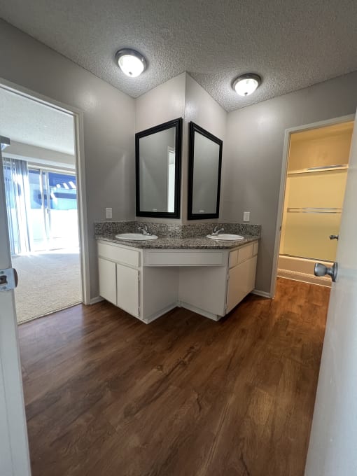 a bathroom with a sink and two mirrors