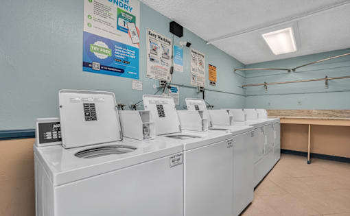 A laundromat with rows of washers and dryers.