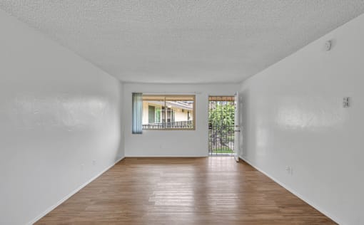 A room with white walls and a wooden floor.