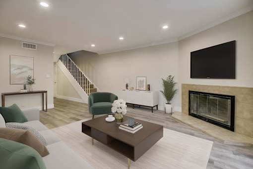 A living room with a fireplace and a television.