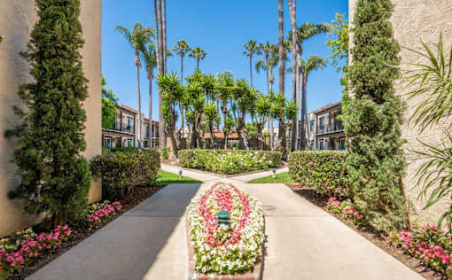A garden pathway with a flower bed in the middle.