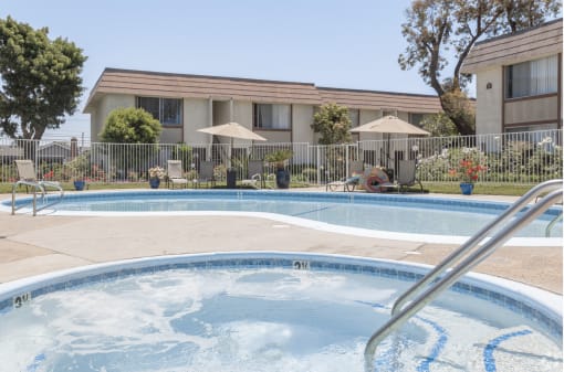 a swimming pool with a building in the background