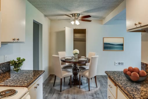 a kitchen and dining room with a table and chairs