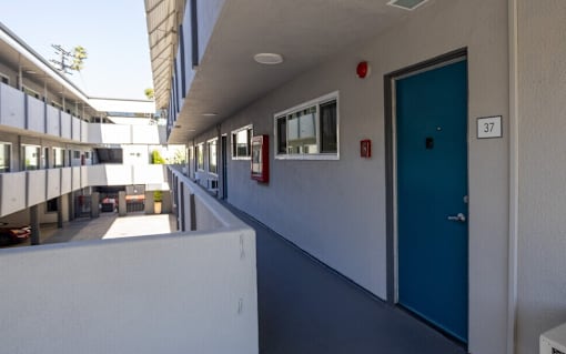 A long hallway with doors numbered 37.