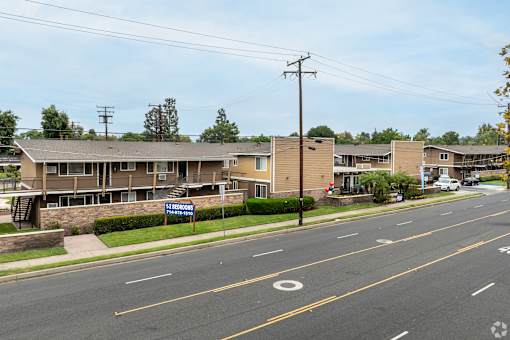 A street view of a residential area with a sign that reads "BROOKHURST".