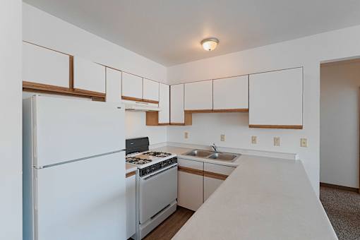 a kitchen with white appliances and white cabinets