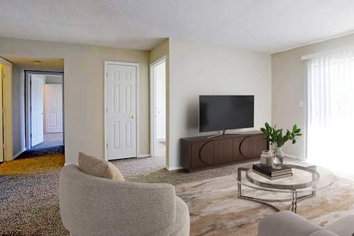 A living room with a television, a chair, and a table with a plant on it.