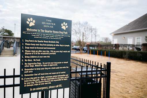 A sign at The Quarter House Dog Park lists the rules for using the area. at The Quarter Lofts Apartments, Mississippi, 39216