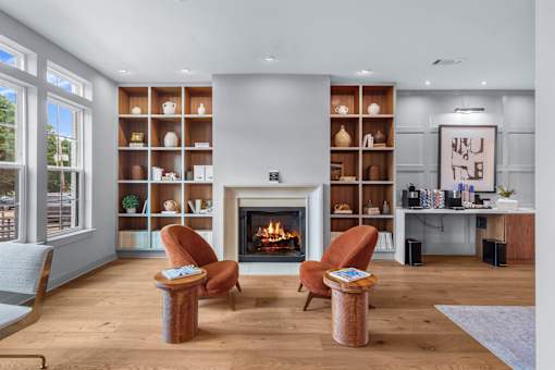 A living room with a fireplace and two chairs. at The Quarter Lofts Apartments, Mississippi