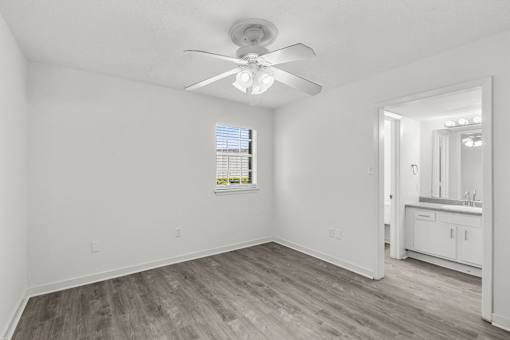 A room with a ceiling fan and a window.
