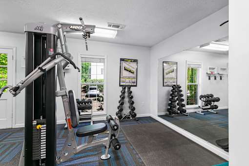 A well equipped gym with a variety of exercise equipment.