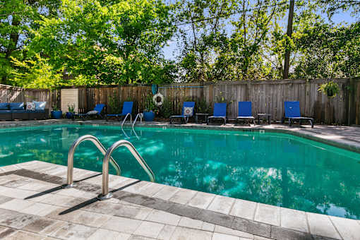 A pool with a metal ladder and a tiled edge.