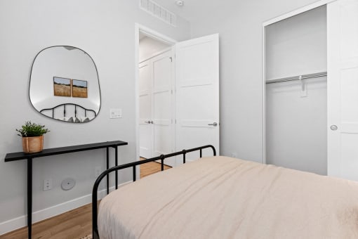 a bedroom with a bed and a mirror and closets at Village of Chandler Apartments, Chandler, 85249