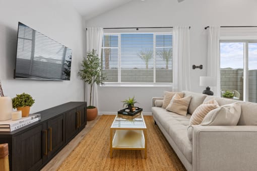 a living room with a couch and a coffee table at Village of Chandler Apartments, Arizona, 85249